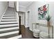 Hallway with wooden stairs, modern decor, and lots of light provides a welcoming and stylish entrance at 1412 W 4Th St, Charlotte, NC 28208