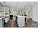 Open-concept kitchen with a center island, stainless steel appliances, and seamless connection to the living area at 1412 W 4Th St, Charlotte, NC 28208