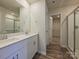 Bathroom with double sink vanity, modern shower, and view to the walk-in closet at 150 Aberdeen Dr, Salisbury, NC 28144