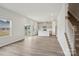 Open-concept living room with vinyl floors, kitchen, and staircase at 150 Aberdeen Dr, Salisbury, NC 28144
