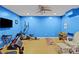 Spacious basement gym area with blue walls, wood flooring, and various exercise equipment at 150 Hidden Oak Dr, Statesville, NC 28677