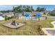 Community pool with lounge chairs, umbrellas, and a playground surrounded by well-maintained lawns at 152 Broadleaf Dr, Denver, NC 28037
