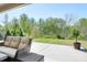 Inviting covered patio with wicker furniture, perfect for relaxing and enjoying the peaceful backyard view at 152 Broadleaf Dr, Denver, NC 28037