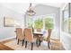 Dining room with a large table, six chairs, a chandelier, and plenty of natural light at 152 Broadleaf Dr, Denver, NC 28037