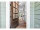 Elegant front door with glass panes, opening to reveal gleaming hardwood floors at 152 Broadleaf Dr, Denver, NC 28037
