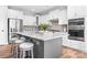 Kitchen island with granite countertops, stainless steel appliances, and seating for three at 152 Broadleaf Dr, Denver, NC 28037