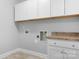 Well-organized laundry room with white cabinets, countertop, and utility connections at 152 Broadleaf Dr, Denver, NC 28037