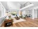Open-concept living room with high ceilings, hardwood floors, and custom built-in shelving at 152 Broadleaf Dr, Denver, NC 28037