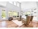 Bright living room with hardwood floors, a cozy sofa, large windows, and custom built-ins at 152 Broadleaf Dr, Denver, NC 28037