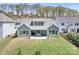 Aerial view of backyard with a covered patio, grill, seating and lush lawn at 152 Broadleaf Dr, Denver, NC 28037