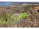 Aerial view of a beautiful home with a well-maintained lawn and a picturesque lake in the background at 16455 Harbor View Rd, Charlotte, NC 28278