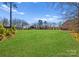 Expansive backyard featuring lush green grass, perfect for outdoor activities and enjoying nature at 16455 Harbor View Rd, Charlotte, NC 28278