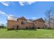 Large backyard featuring a well-maintained lawn, brick exterior, and small outdoor area with seating at 16455 Harbor View Rd, Charlotte, NC 28278