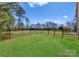 Well-maintained fenced backyard with a lush lawn providing ample space for various outdoor activities and play at 16455 Harbor View Rd, Charlotte, NC 28278