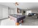 Large finished basement featuring a pool table, kitchenette, and comfortable seating area at 16455 Harbor View Rd, Charlotte, NC 28278