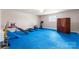 Bright basement area with blue floor tiles and work-out equipment at 16455 Harbor View Rd, Charlotte, NC 28278
