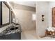 Bright bathroom with vanity with dark granite, shower and built in tiled shelf at 16455 Harbor View Rd, Charlotte, NC 28278