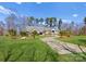 Expansive front yard of a brick home with palm trees lining the driveway creating a welcoming, tropical feel at 16455 Harbor View Rd, Charlotte, NC 28278