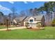 Beautiful brick home showcasing a well-manicured lawn and a driveway leading to a two-car garage with a basketball hoop at 16455 Harbor View Rd, Charlotte, NC 28278