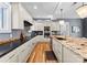 An elegant kitchen with stainless steel appliances, granite countertops, hardwood floors, and modern lighting at 16455 Harbor View Rd, Charlotte, NC 28278