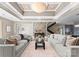 A spacious living area featuring a decorative ceiling, a view of the stairway, and modern, neutral furnishings at 16455 Harbor View Rd, Charlotte, NC 28278