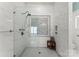 Beautiful glass shower with large format tile and mosaic accent window at 16455 Harbor View Rd, Charlotte, NC 28278