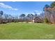 Expansive grassy yard displaying the side and back of a classic brick home, blending nature and architectural charm at 16455 Harbor View Rd, Charlotte, NC 28278