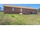 The backyard features a brick exterior and a spacious lawn, perfect for outdoor activities at 1922 Dogwood Flower Ln, Lincolnton, NC 28092