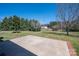 A concrete patio overlooks the expansive, tree-lined backyard at 1922 Dogwood Flower Ln, Lincolnton, NC 28092