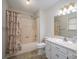 Well-lit bathroom with a shower-tub combo, vanity with ample counter space, and a decorative shower curtain at 1922 Dogwood Flower Ln, Lincolnton, NC 28092