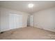 This bedroom features neutral walls, carpeted floors and double closets for ample storage at 1922 Dogwood Flower Ln, Lincolnton, NC 28092