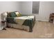 Cozy bedroom with a bed and decorative pillows, a side table, and shelving at 1922 Dogwood Flower Ln, Lincolnton, NC 28092