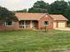 Inviting single-story home with brick exterior, manicured lawn, and an attached two-car garage at 1922 Dogwood Flower Ln, Lincolnton, NC 28092