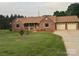 Charming single-story brick home features a well-manicured lawn and a welcoming front porch at 1922 Dogwood Flower Ln, Lincolnton, NC 28092