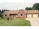 Charming red brick ranch home features a well-manicured lawn and a cozy covered front porch at 1922 Dogwood Flower Ln, Lincolnton, NC 28092