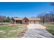 Traditional brick home featuring a cozy porch, two-car garage, and a spacious driveway at 1922 Dogwood Flower Ln, Lincolnton, NC 28092