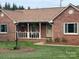 Beautiful brick home with a cozy front porch, mature landscaping, and a well-maintained lawn at 1922 Dogwood Flower Ln, Lincolnton, NC 28092