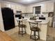 Traditional kitchen with black appliances and a center island with bar stool seating at 1922 Dogwood Flower Ln, Lincolnton, NC 28092
