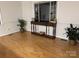 Bright living room with hardwood floors, a console table, and natural light at 1922 Dogwood Flower Ln, Lincolnton, NC 28092