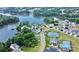 An aerial view of the community featuring a lake, well-maintained landscaping, a pool and tennis courts at 23128 Goose Down Ln, Lancaster, SC 29720