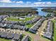 Stunning aerial view of the community featuring manicured lawns, pool, tennis courts, and a beautiful lake at 23128 Goose Down Ln, Lancaster, SC 29720