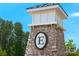 Community entrance featuring a stone structure with a sign in a lush, green neighborhood at 23128 Goose Down Ln, Lancaster, SC 29720