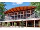 The exterior view showcases a unique screened structure with kayaks stored underneath at 23128 Goose Down Ln, Lancaster, SC 29720