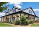 A detailed exterior shows a charming building with ample covered porch space, set amidst lush landscaping at 23128 Goose Down Ln, Lancaster, SC 29720