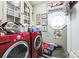 Convenient laundry room with modern washer and dryer, unique decor, and ample storage at 23128 Goose Down Ln, Lancaster, SC 29720