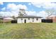 Expansive backyard features lush greenery and a white-painted brick home exterior, complemented by a dark-stained wooden fence at 2318 Knight Dr, Gastonia, NC 28052
