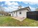 A brick patio provides a relaxing spot in the fenced backyard of this white brick home, surrounded by flowering ground cover at 2318 Knight Dr, Gastonia, NC 28052