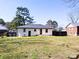 Large backyard with a well-maintained lawn, fenced area, and the rear view of the house at 2318 Knight Dr, Gastonia, NC 28052