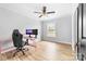 Bright bedroom showcasing wood-look flooring, a ceiling fan, and a pink gaming desk at 2318 Knight Dr, Gastonia, NC 28052