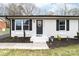 Charming brick home featuring a black front door with a decorative wreath and manicured landscaping at 2318 Knight Dr, Gastonia, NC 28052